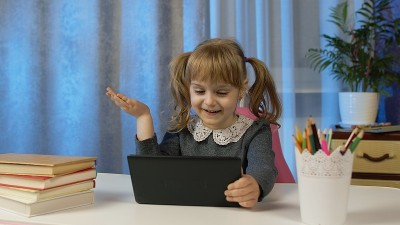 女小学生和老师在家里用数码平板电脑上课