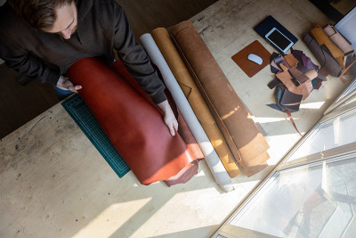 在皮革车间，工匠正在拆包天然材料。Leatherwork
