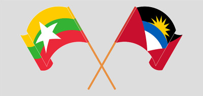 Crossed and waving flags of Antigua and Barbuda an