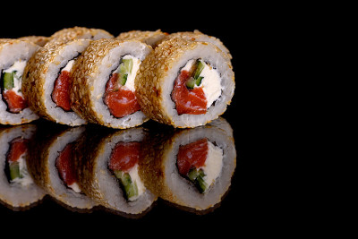 Fresh delicious beautiful sushi rolls on a dark ba