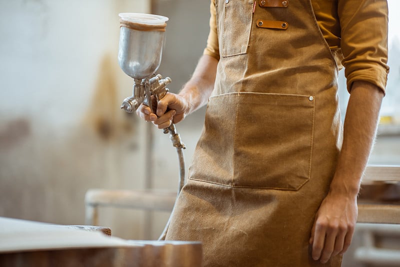 Painting wooden product with a spray gun