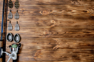 flat lay with fishing tackle, fishing rod and plas