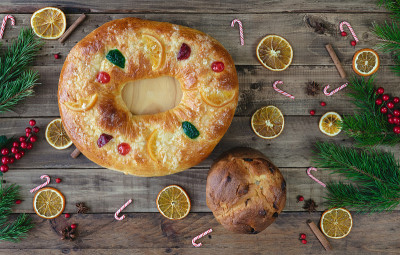 Roscón德雷耶斯和潘妮托妮在木制的基础上与圣诞装饰。副本的空间。国王的甜点和潘妮朵妮。