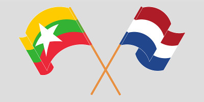 Crossed and waving flags of Myanmar and the Nether