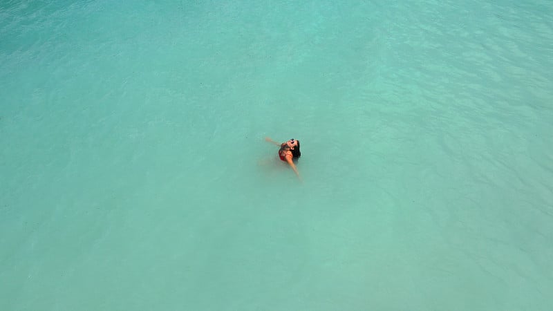 Aerial view of young beautiful woman in red bikini