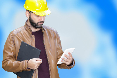 工程师建筑工人操作触控板装置。商业，工程和建筑概念