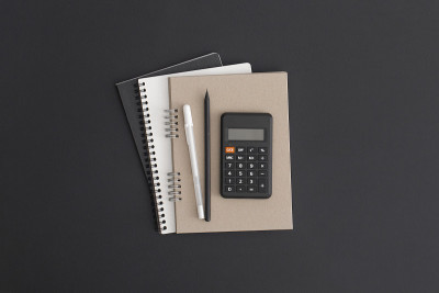 Notebook on black leather background. Flat lay com