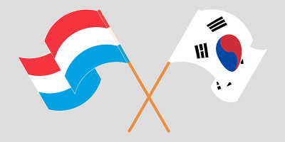 Crossed and waving flags of Luxembourg and South K