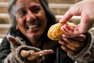 手给面包或食物模糊幸福的脸无家可归的男性