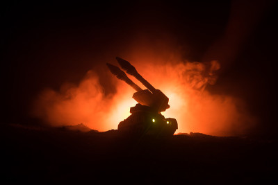火箭发射与火云。火箭导弹和弹头瞄准夜晚灰暗的天空的战斗场景。《战争背景》中的火箭战车
