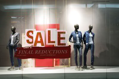贴着促销海报的服装店橱窗
