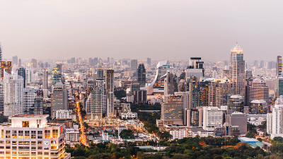 鸟瞰图曼谷现代办公大楼，公寓在曼谷市区的黄昏。有城市和交通灯。