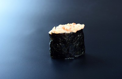 深色的石头背景上是五颜六色的海鲜卷和米饭
