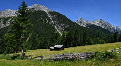 美丽的山地景观与高山小屋和落叶松森林在南蒂罗尔附近的布鲁尼科，博尔扎诺。意大利。
