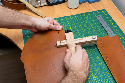 Cutting brown leather stripe for a belt with a str