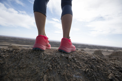 Successful woman trail runner legs  on sand desert