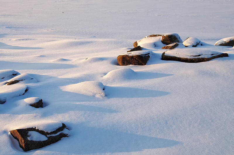 冰封的河上雪地里的石头