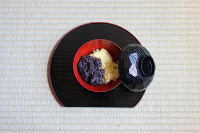 日本料理传统的豆沙和蒸小米甜点与黑色餐具