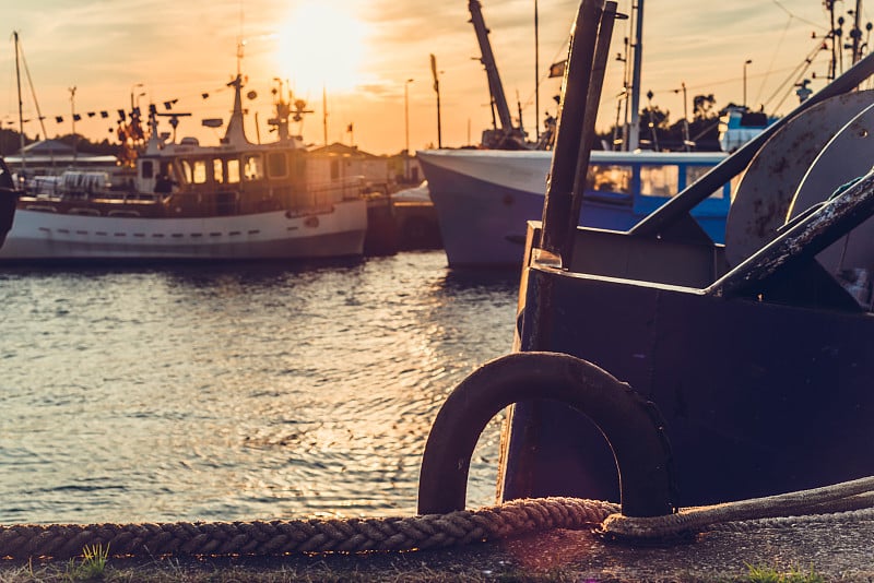 Ship in the harbor at sunset