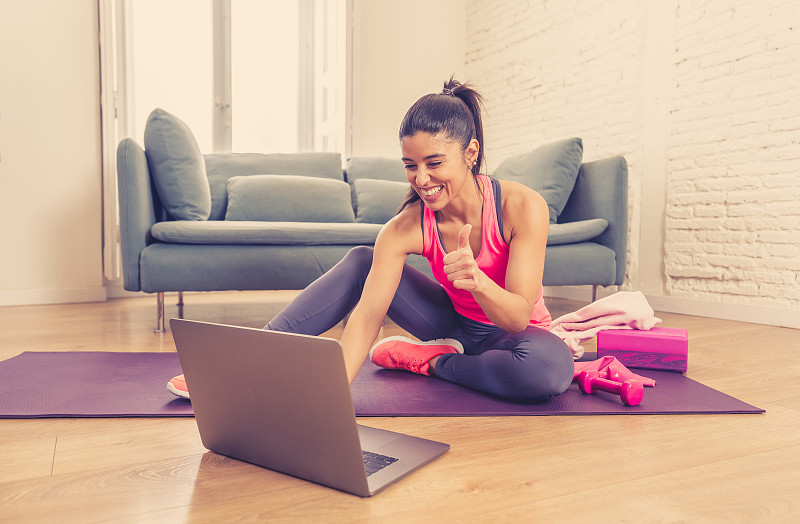 Young beautiful latin woman working out at home co