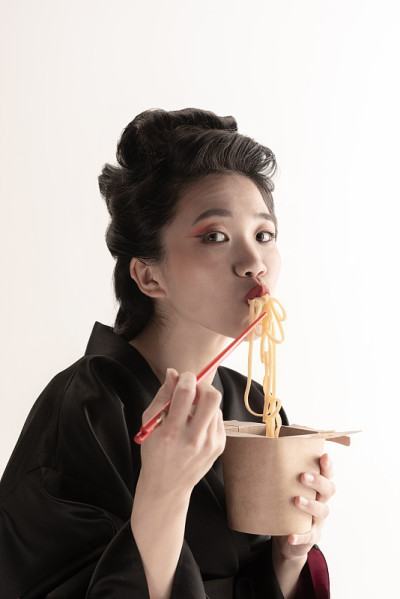 年轻美丽的日本人的肖像，妇女在民族服装和服摆出孤立的白色工作室背景。