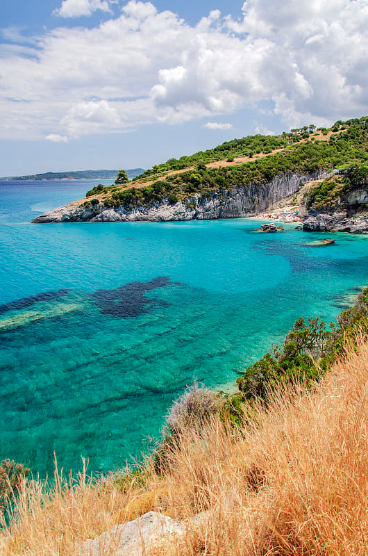 Picturesque Xigia sandy beach with sulphur waters.