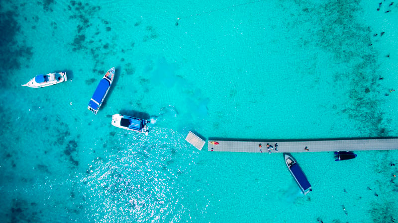 top view of tourist speed boat approaching to floa