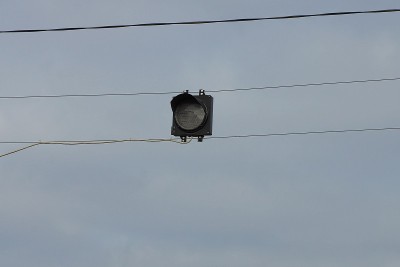traffic light with one gray lamp on wires