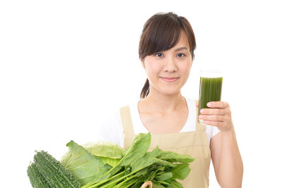 拿着一杯蔬菜汁的女人