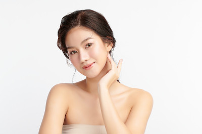 美丽年轻的亚洲女性与干净的新鲜皮肤在白色的背景，面部护理，面部治疗，美容和水疗中心，亚洲女性肖像。
