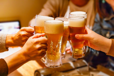 酒馆里许多人举杯互敬的手和大杯啤酒