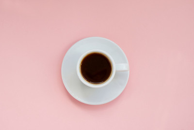 White cup of strong coffee on pink background Copy