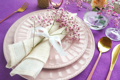 festive table setting on a shiny purple table two 