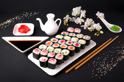 寿司菜单。日本的食物。三文鱼，金枪鱼，黄瓜，黄瓜，鳄梨，奶酪，鳗鱼，虾，蟹棒，鱼子酱。黑色背景。