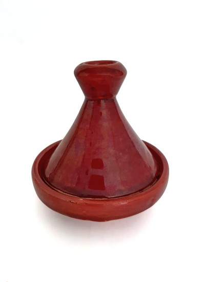 Red terracotta tajin isolated on white background.