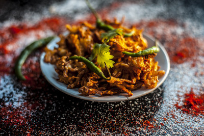 将Piyaz pakora/bhaji/bhajji/bhajiya/bajji放在一个玻璃盘子里，