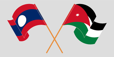 Crossed and waving flags of Laos and Jordan