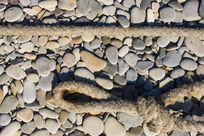 old marine rope on the pebble beach