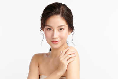 美丽年轻的亚洲女性与干净的新鲜皮肤在白色的背景，面部护理，面部治疗，美容和水疗中心，亚洲女性肖像。
