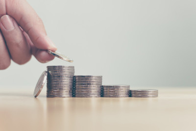 概念省钱金融业务投资。男人的手放硬币叠步成长成长价值