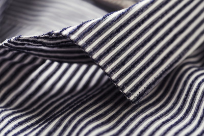 Close up of men's striped shirt. Cotton fabric.