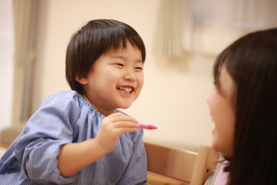 Image of a boy and a nursery teacher drawing