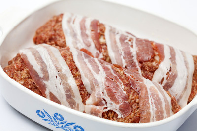 生鸡蛋和蔬菜馅肉卷覆盖培根