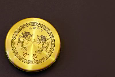 古老的中国指南针用于风水，金色的项目与龙在顶部，在黑暗的背景。