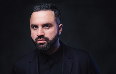 Bearded male dressed in a suit.