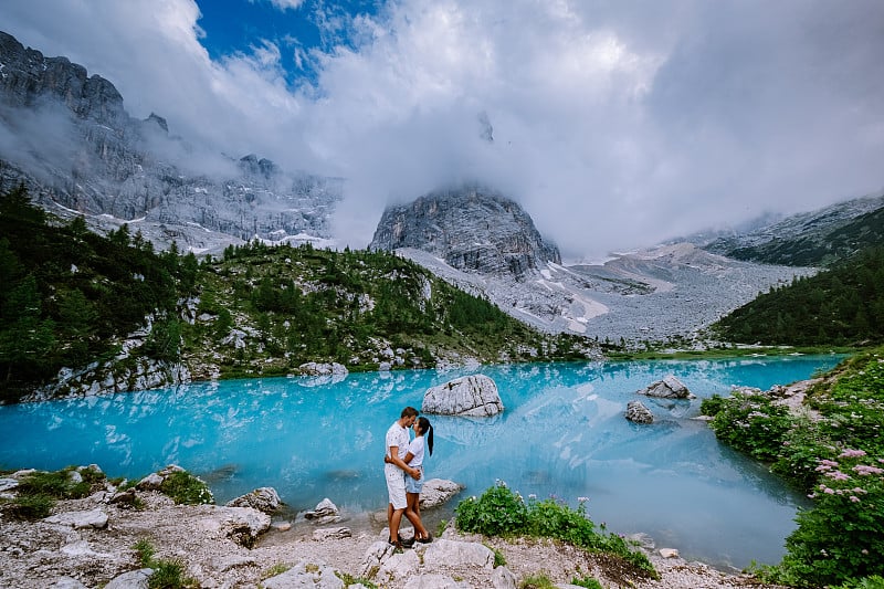 Couple visit the blue green lake in the Italian Do