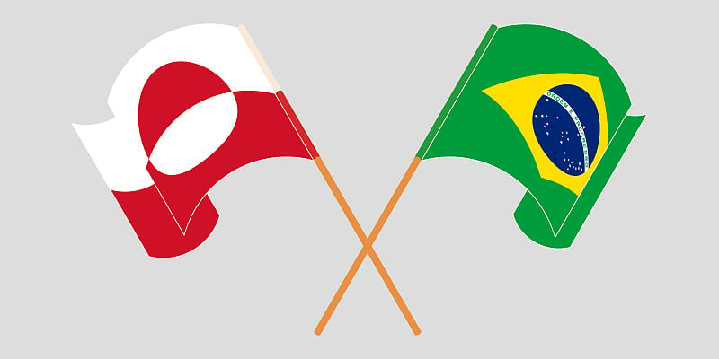 Crossed and waving flags of Greenland and Brazil