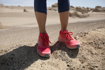 Successful woman trail runner legs  on sand desert
