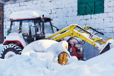 小拖拉机在冬天的雪地里
