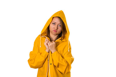 一个穿着黄色雨衣的女孩的肖像。隔离在白色背景上